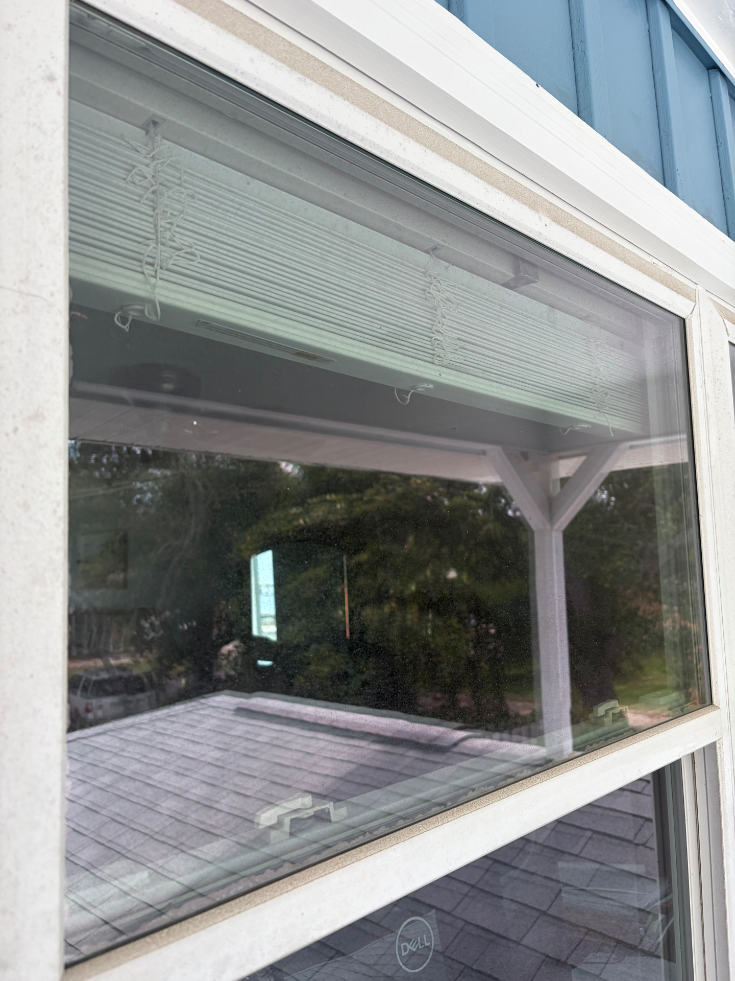 Before: hard water and mineral haze on a Navarre window